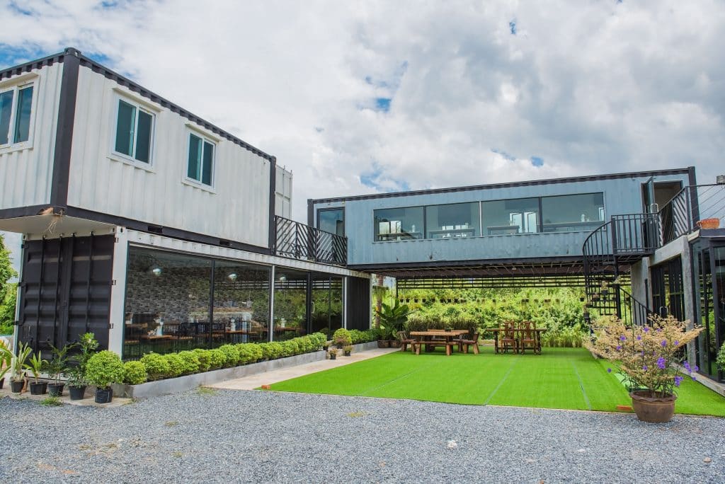 modern,metal,building,made,from,shipping,containers,and,blue,sky