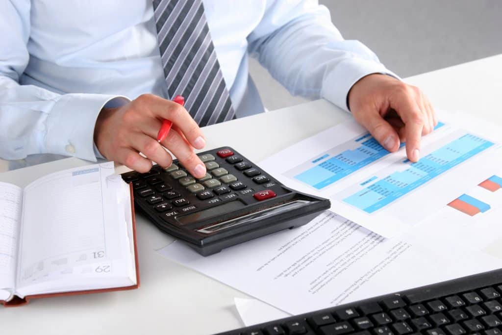 businessman,in,suit,working,on,laptop,,at,a,table,in