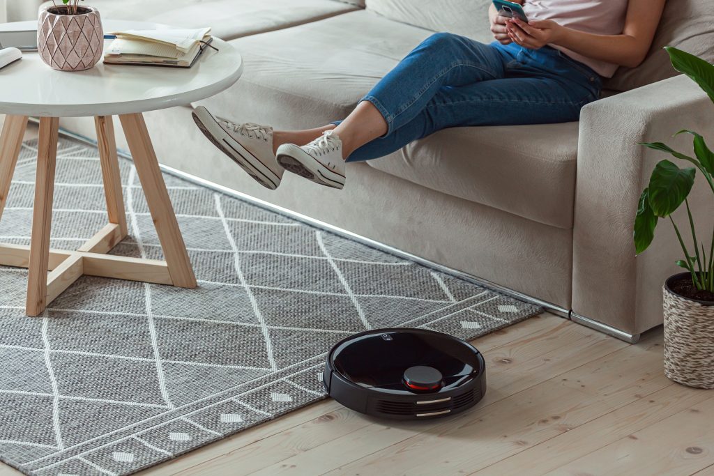 robotic,vacuum,cleaner,cleaning,carpet,,woman,remote,control,mobile,phone