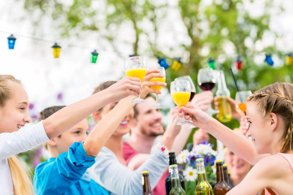 friends,and,neighbors,toasting,on,garden,party