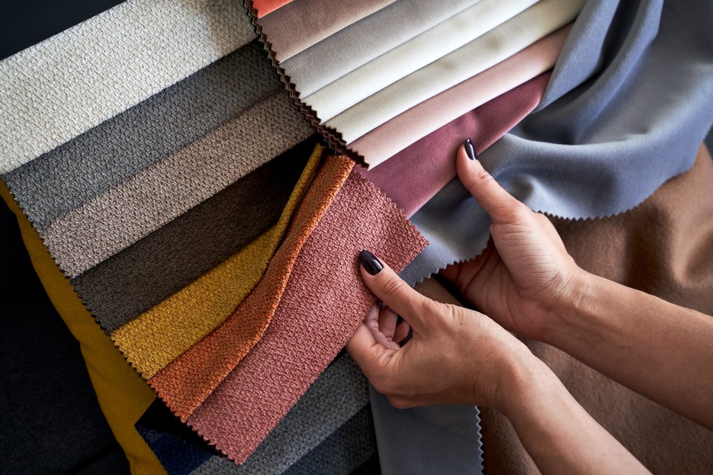 choosing,upholstery,fabric,color,and,texture,from,various,colorful,samples