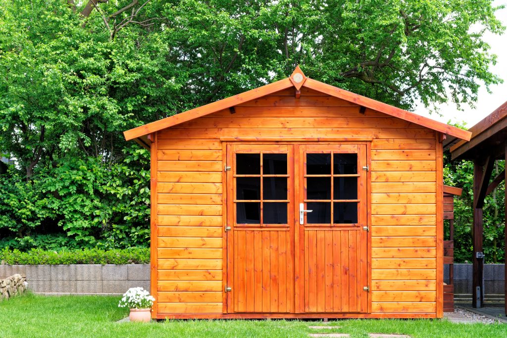 frontal,view,of,wooden,garden,shed,glased,in,teak,color