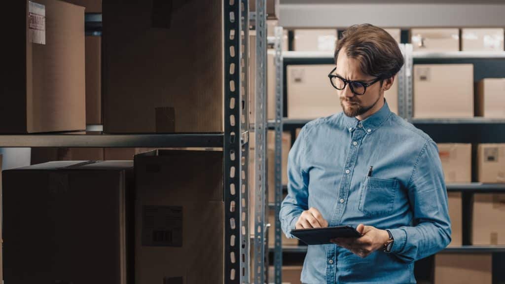 warehouse,inventory,manager,uses,tablet,computer,to,check,stock,on