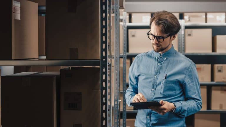 warehouse,inventory,manager,uses,tablet,computer,to,check,stock,on