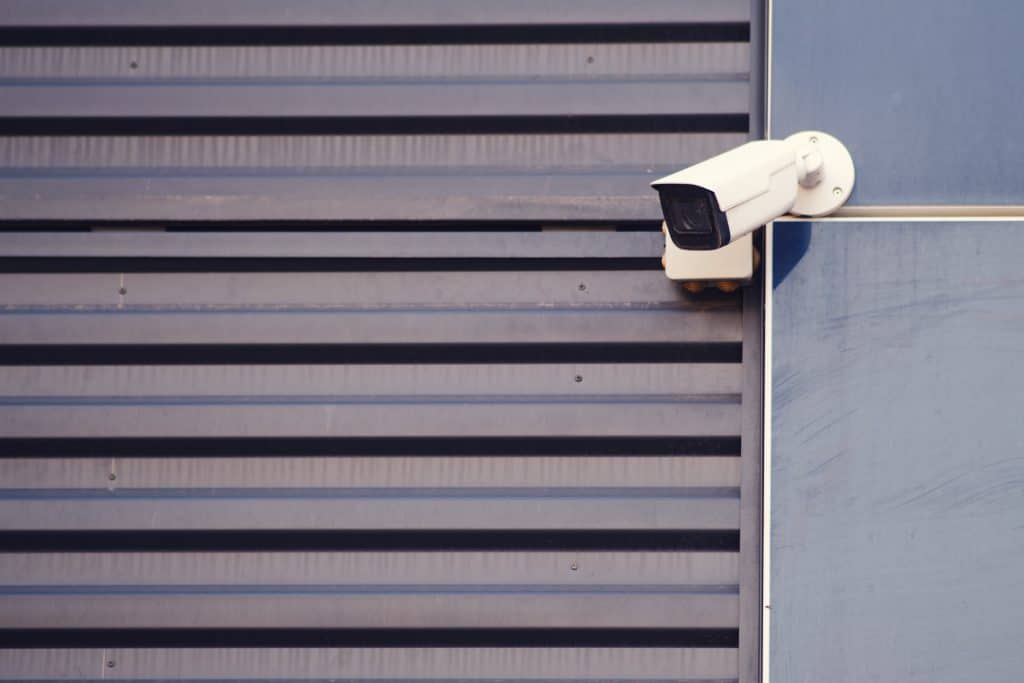 surveillance,camera,at,the,garage,door,on,the,facade,of