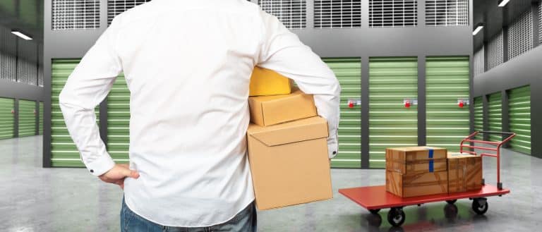 man,near,storage,room.,guy,with,boxes,back,camera.,man